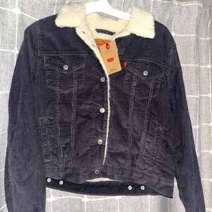 Levi’s corduroy bluish grey jacket with white teddy bear fur collar.